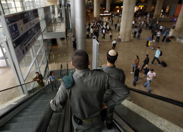 Israeli border police ride an escalator at Ben Gurion International Airport near Tel Aviv April 15, 2012. Hundreds of police officers were deployed in and around Tel Aviv's Ben Gurion Airport, Israel's main gateway to the world, as a pro-Palestinian "fly-in" to Tel Aviv got off to a slow start on Sunday after Israel scrambled to block activists from boarding flights in Europe. REUTERS/Ronen Zvulun