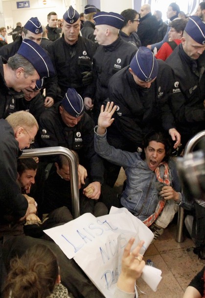 Police officers intervene as around 100 pro-Palestinian activists stage a protest at Brussels national airport in Zaventem early April 15, 2012. Some 1,200 Palestinian supporters throughout Europe have bought plane tickets for an April 15 visit to the West Bank as part of a campaign called "Welcome to Palestine". Organisers said the aim was to help open an international school and a museum, but Israel has denounced the activists as provocateurs and said it would deny entry to anyone who threatened public order. REUTERS/Sebastien Pirlet