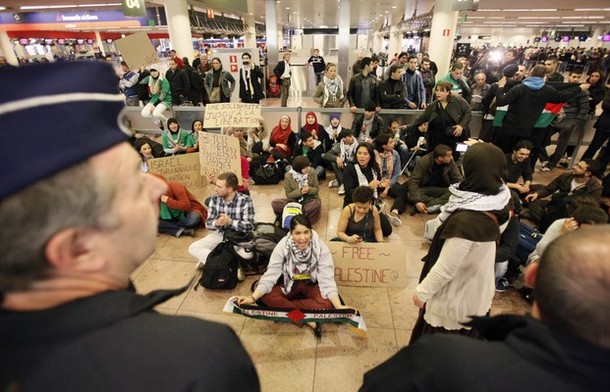 Demonstrators sit as around 100 pro-Palestinian activists stage a protest at Brussels national airport in Zaventem early April 15, 2012. Some 1,200 Palestinian supporters throughout Europe have bought plane tickets for an April 15 visit to the West Bank as part of a campaign called "Welcome to Palestine". Organisers said the aim was to help open an international school and a museum, but Israel has denounced the activists as provocateurs and said it would deny entry to anyone who threatened public order. REUTERS/Sebastien Pirlet