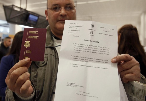 A would-be passenger poses with his passport and a letter denying him access to Israel as around 100 pro-Palestinian activists stage a protest at Brussels national airport in Zaventem early April 15, 2012. Some 1,200 Palestinian supporters throughout Europe have bought plane tickets for an April 15 visit to the West Bank as part of a campaign called "Welcome to Palestine". Organisers said the aim was to help open an international school and a museum, but Israel has denounced the activists as provocateurs and said it would deny entry to anyone who threatened public order. REUTERS/Sebastien Pirlet