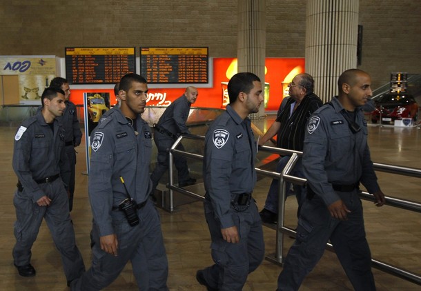 Israeli police walk in the arrival hall at Ben Gurion International Airport near Tel Aviv April 15, 2012. Hundreds of police officers were deployed in and around Tel Aviv's Ben Gurion Airport, Israel's main gateway to the world, as a pro-Palestinian "fly-in" to Tel Aviv got off to a slow start on Sunday after Israel scrambled to block activists from boarding flights in Europe. REUTERS/Ronen Zvulun
