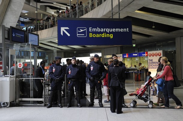 French police stand guard next to a gate at Charles-de-Gaulle airport in Roissy near Paris July 8, 2011. A Hungarian airline stopped dozens of French activists heading for a pro-Palestinian "fly-in" in Israel from boarding a plane in Paris on Thursday. Some 600 people from around Europe, of which roughly 350 are from France, are trying to visit the city of Bethlehem at the invitation of a Palestinian group in an operation dubbed "Welcome to Palestine".       REUTERS/Gonzalo Fuentes
