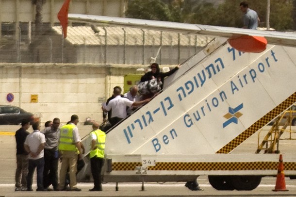 Pro-Palestinian activists are escorted onto a plane heading back to Belgium at Israel's  Ben Gurion international airport near Tel Aviv on April 15, 2012. Israel barred 40 pro-Palestinian activists who had flown in for a "Welcome to Palestine" campaign, detaining 40 passengers on suspicion of being part of the fly-in move, better known as the "flytilla," with all now likely to be deported as hundreds more would-be protesters were stranded at airports across Europe.   AFP PHOTO/JACK GUEZ