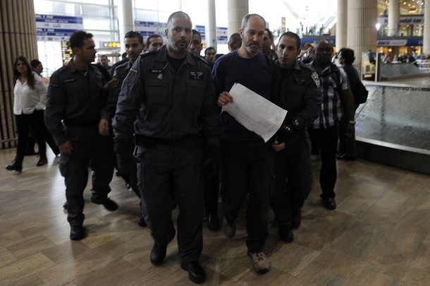 Israeli policemen arrest an Israeli left